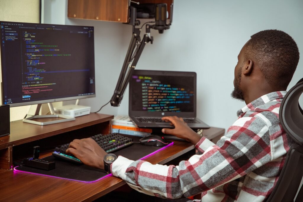 a student coding a website on a laptop