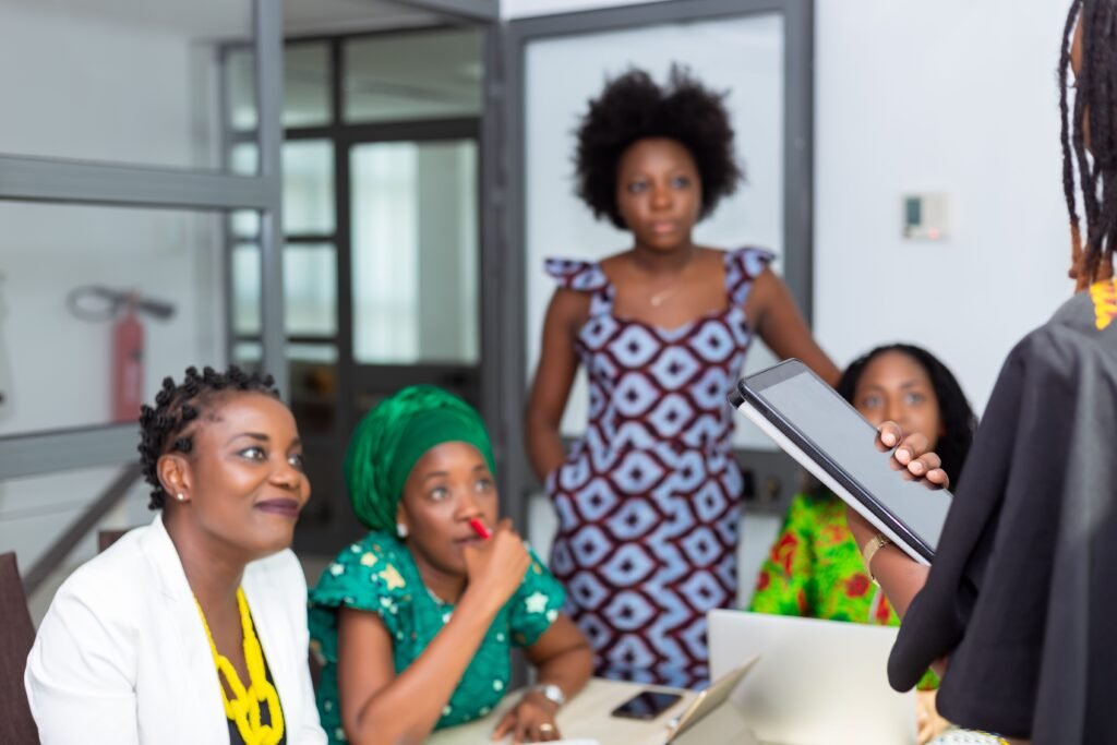 African professionals communicating during a workplace meeting